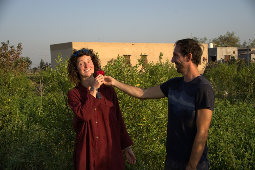 Man and woman laughing together in a field