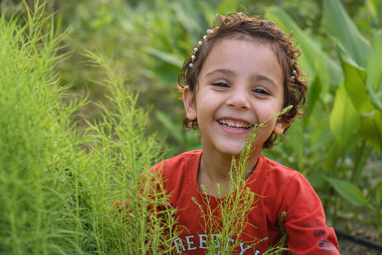 Happy child smiling in green fields